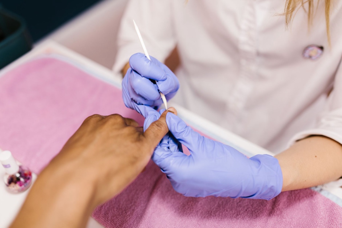 Professional manicure tools on a neutral background.