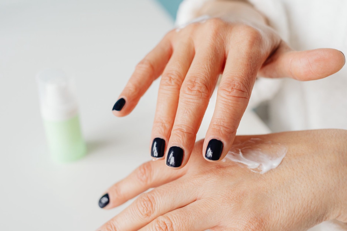 Close-up of cuticle oil being massaged into fingernails